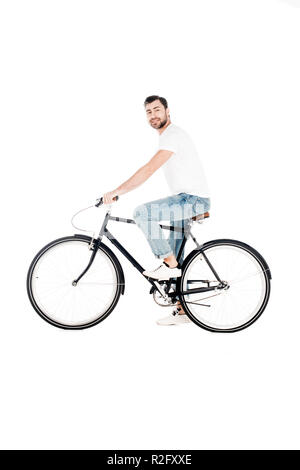 Handsome smiling young adult riding bicycle while looking at camera isolated on white Stock Photo