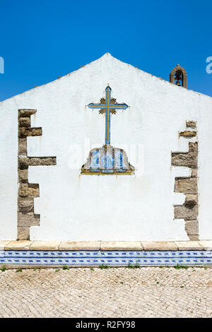 Cross made of azulejos on a chapel wall, Ericeira, Lisbon Coast, Portugal Stock Photo