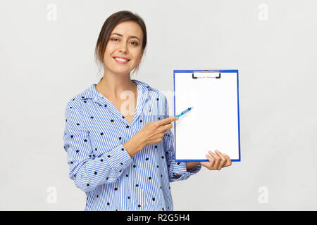 Beautiful woman point pen on clipboard, isolated on white background Stock Photo