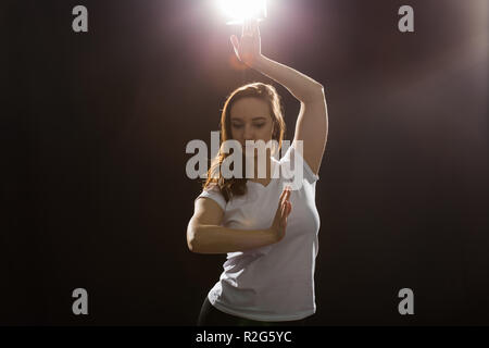 Young woman jazz funk dancer exercising dance moves in studio Stock Photo