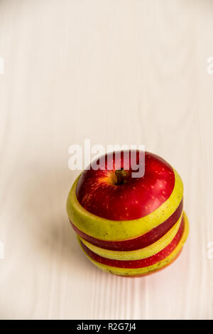 Mixed slices of red and green apple on white close Stock Photo