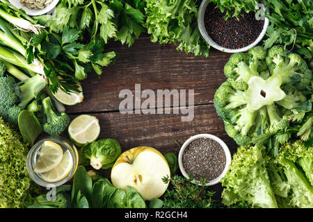 Frame of vegetables, fruit, superfood and herbs top view. Healthy food ingredients background. Celery, parsley, onion, green apple, Brussels sprouts,  Stock Photo