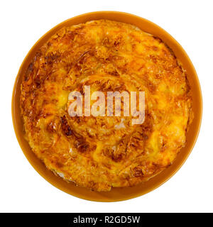 Top view of national festive Bulgarian cheese filo pie Banitsa served on clay plate on blue tablecloth. Isolated over white background Stock Photo