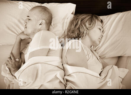 Handsome mature man and beautiful  woman taking a nap together Stock Photo