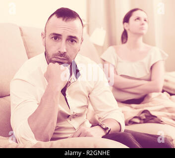 Sad male is depressing and husband is supporting him at home. Stock Photo