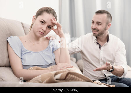 Sad female is depressing and husband is supporting her at home. Stock Photo