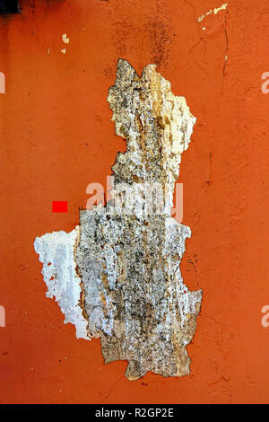 Paint and plaster peels of an orange wall Stock Photo