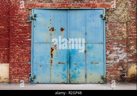 Old warehouse rusty entry with aged red brick wall texture may be used for graphic design Stock Photo