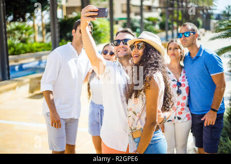 Group of six happy friends taking selfie during sunny summer day Stock Photo