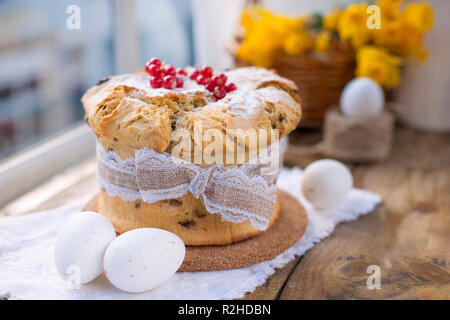 Easter cupcake on the wooden window. Bouquet of spring flowers narcissus. Greeting card for the holiday. Free space for text Stock Photo