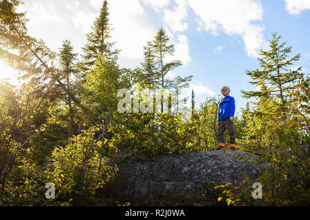 Boy hiking through a forest, Lake Superior Provincial Park, United States Stock Photo