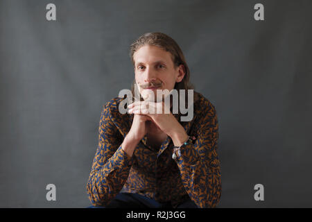 Portrait confident young man with handlebar mustache Stock Photo