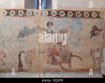 ANANURI, GEORGIA - SEPTEMBER 24, 2018: old fresco on wall of Assumption Church depicts St. George the Victorious Stock Photo