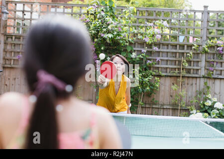 Mother and daughter playing table tennis Stock Photo