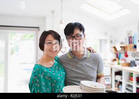 Portrait happy couple in kitchen Stock Photo