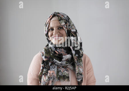 Portrait smiling, confident woman wearing floral hijab Stock Photo