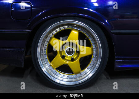 Legendary alloy two-piece sport rims on beautiful wheels in polished and gold color Stock Photo