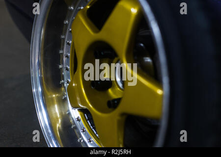 Legendary alloy two-piece sport rims on beautiful wheels in polished and gold color Stock Photo