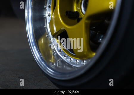 Legendary alloy two-piece sport rims on beautiful wheels in polished and gold color Stock Photo