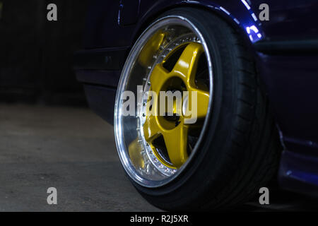 Legendary alloy two-piece sport rims on beautiful wheels in polished and gold color Stock Photo