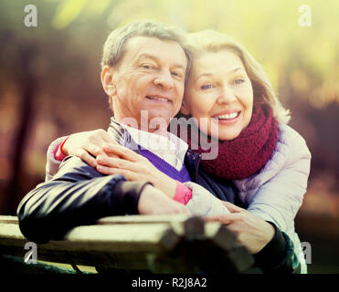 Portrait of joyful mature spouses enjoying spending time outdoors at spring. Focus on man Stock Photo