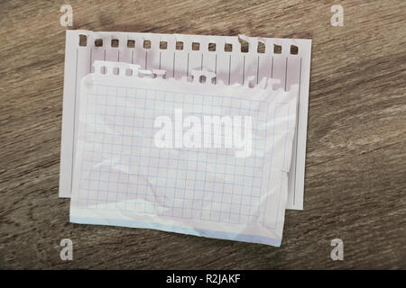 Torn sheets in notebook on table Stock Photo