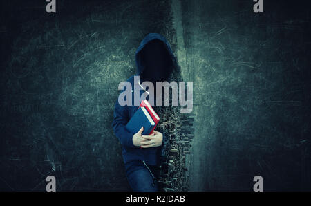 Anonymous with invisible face wearing hood, hiding identity, holding two books. The unknown reader double exposure effect over cityscape and blackboar Stock Photo