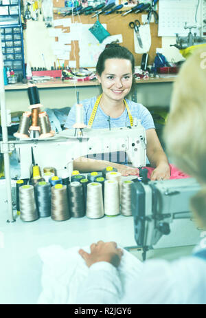 Portrait of two professional female tailors working in the sewing workshop Stock Photo