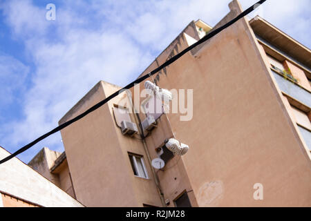 Shoes hanging from telephone wire Stock Photo