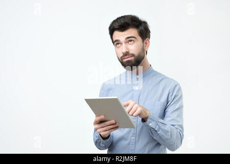 Handsome man using tablet on white background. Studio shoot Stock Photo