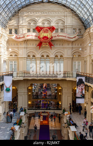 GUM department store on Red Square, Moscow, Russia. The end of one of it's galleries with the store insignia. Stock Photo