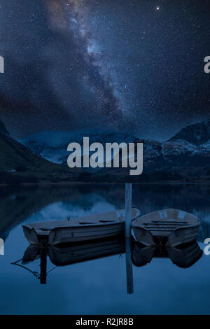 Stunning vibrant Milky Way composite image over landscape of Llyn Nantlle in Snowdonia National Park Stock Photo