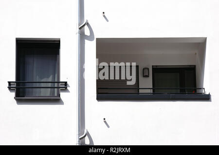 A new modern balcony of an apartment of an apartment building with a bright white facade, Stock Photo