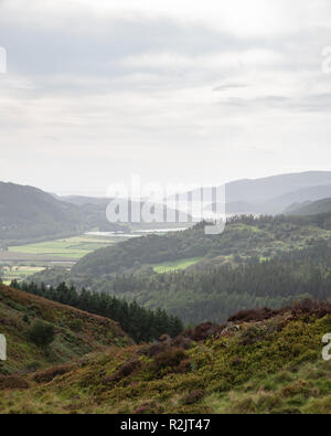 Beautiful landscape image of view from Precipice Walk in Snowdonia overlooking Barmouth and Coed-y-Brenin forest during rainy afternoon in September