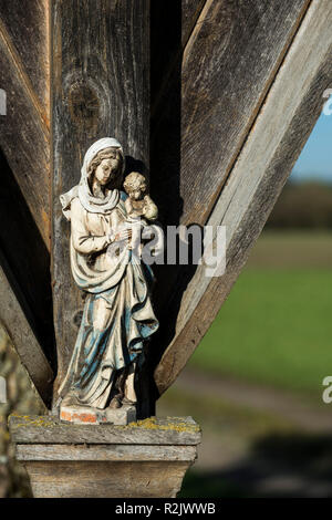 weathered Virgin Mary figure with child at a wayside cross, Upper Bavaria, Bavaria, Germany, Europe Stock Photo