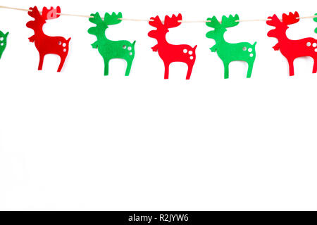 Christmas red and green reindeer in a row. Isolated on white background. Twine. Copy space at the bottom. Stock Photo