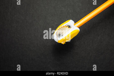 Pencil and sharpener on black background, top view Stock Photo