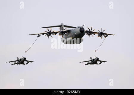 BERLIN - APR 27, 2018: German Air Force Airbus A400M plane aerial refuelling two Tornado fighter jet bombers. Stock Photo