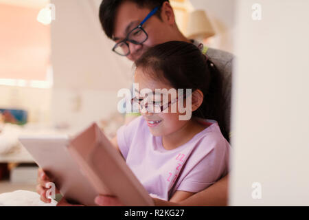 Father and daughter using digital tablet Stock Photo