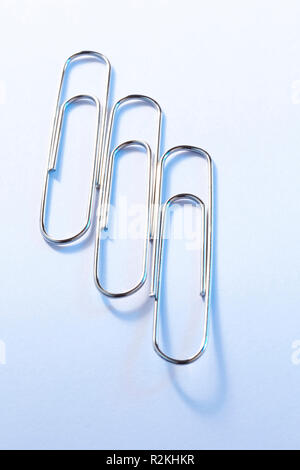 Three giant paper clips Stock Photo