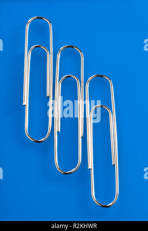 Three giant paper clips Stock Photo