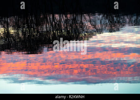 An Autumnal Sunset Reflecting in the Waters of Lake Windermere in the Lake District National Park Cumbria England United Kingdom UK Stock Photo