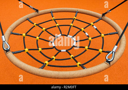 A landing place in the form of a cobweb on a children's swing which is called a bird's nest Stock Photo