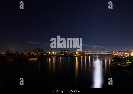 Night Kyiv panorama on Dnipro and gavanskiy bridge on background with stars and deep color water Stock Photo