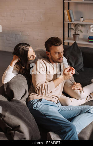 beautiful romantic couple relaxing together on couch at home Stock Photo