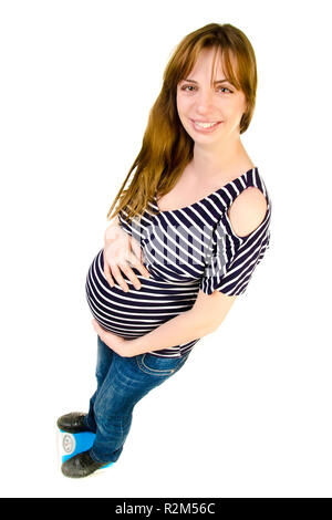 pregnant woman standing on a scales Stock Photo