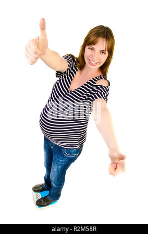 pregnant woman on a scales giving a thumb up Stock Photo