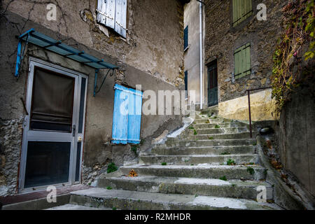 Stairs in the old village center in autumn and wooden shutters Stock Photo