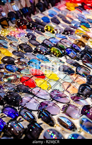 Sunglasses on display at a stall selling them in many different styles. Stock Photo