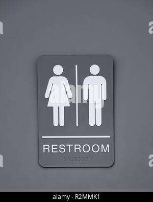 A gray and white unisex restroom sign on a bathroom door. Stock Photo